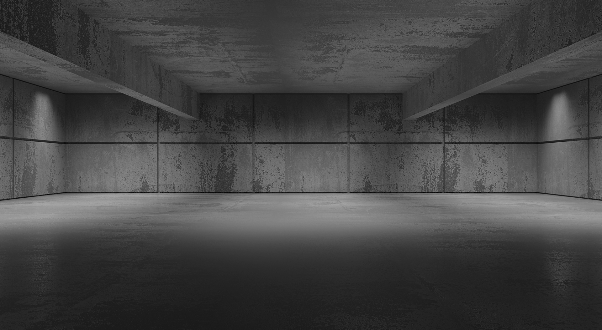 Leerer Betonraum mit Betonwänden, deckenhohe Balken und Schatten in den Ecken. Schwarzweiß.